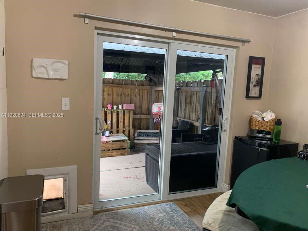 15228 Southwest 111th Street Miami, FL 33196 - Photo 7 of 27 a kitchen with a refrigerator and a stove
