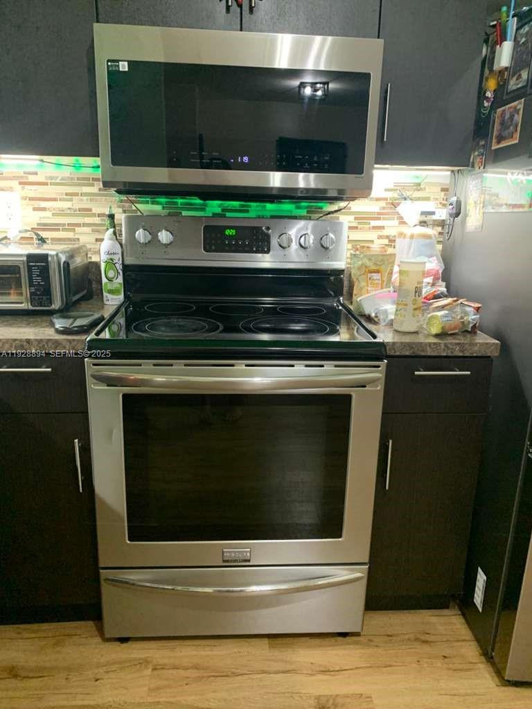 15228 Southwest 111th Street Miami, FL 33196 - Photo 9 of 27 a stove top oven sitting inside of a kitchen