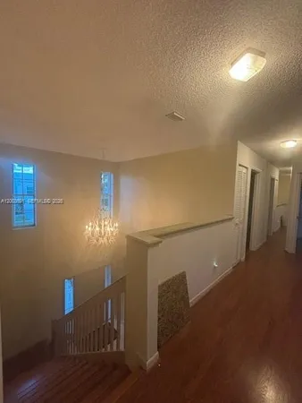 a view of an empty room and wooden floor