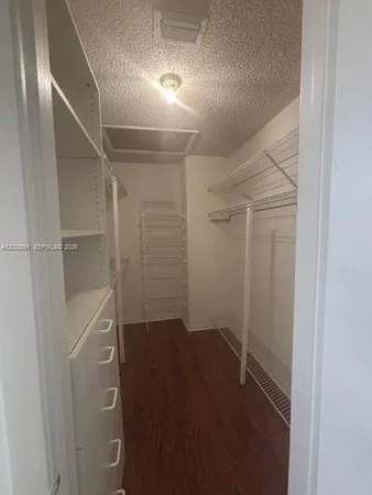 a view of furniture and chandelier in a room