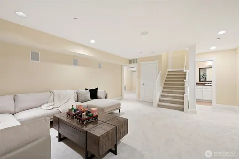 a living room with furniture and a stairs