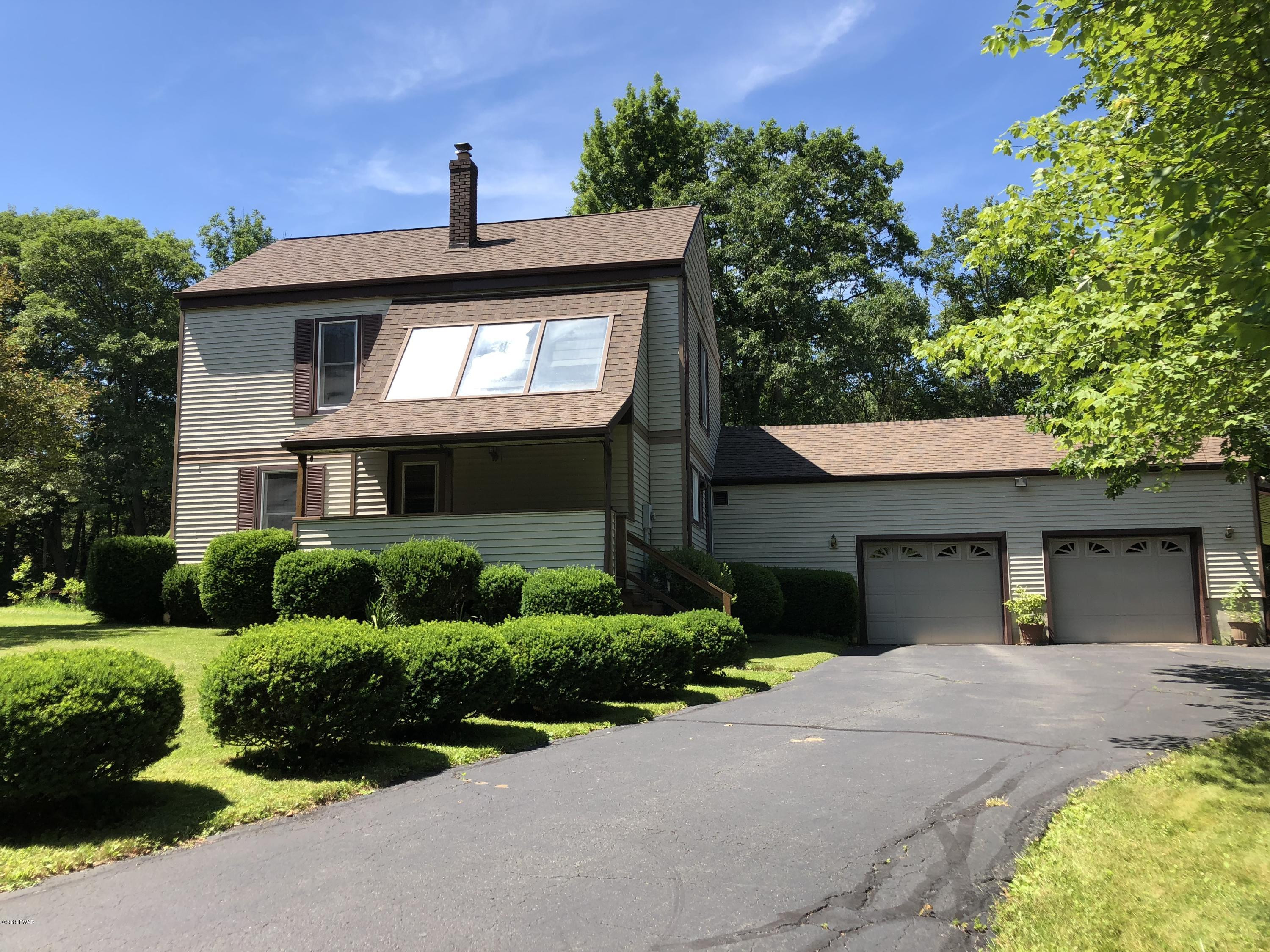 57 Log Road Lake Ariel, PA 18436 - Photo 2 of 18 a front view of a house with a yard