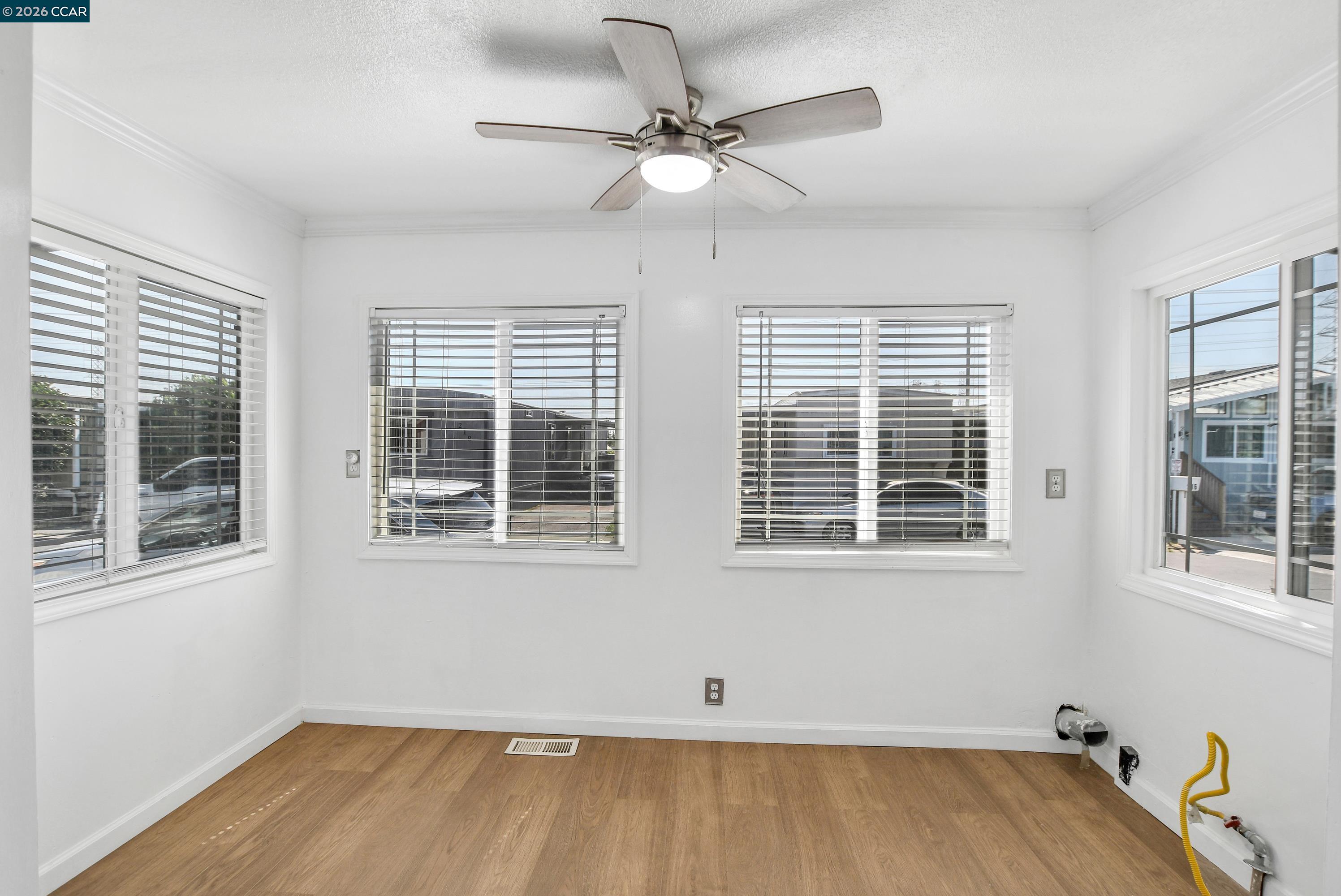 237 Orangevale Pittsburg, CA 94565 - Photo 7 of 21 an empty room with a window and ceiling fan