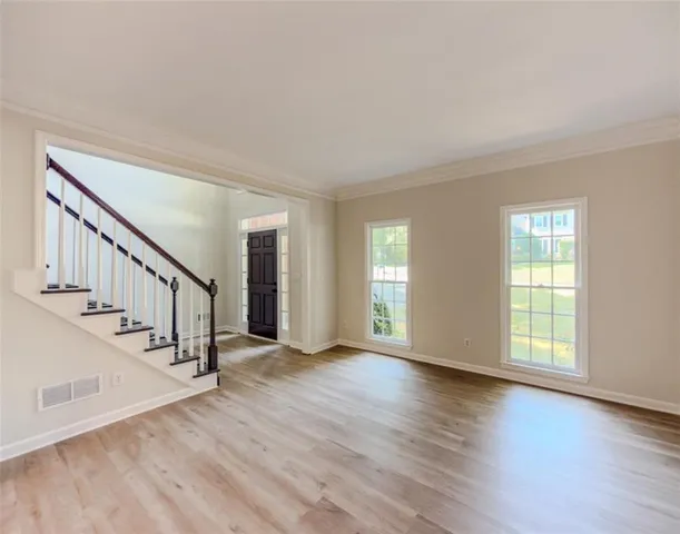 a large kitchen with kitchen island a sink wooden floor and glass doors