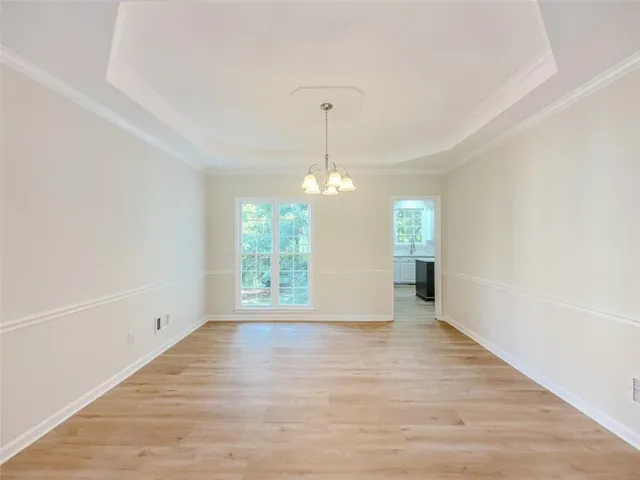a view of a kitchen with wooden floor and electronic appliances