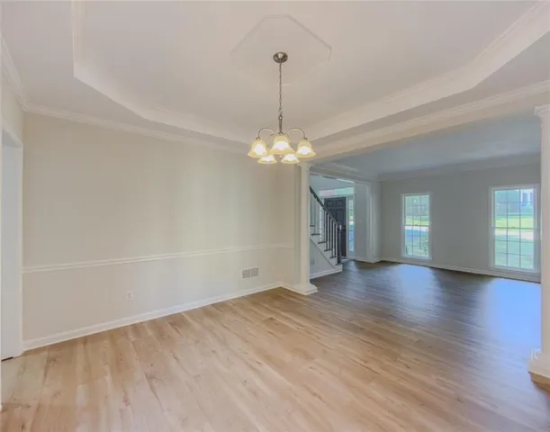 a kitchen with granite countertop white cabinets and a sink
