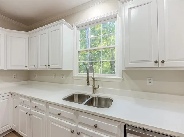 an empty room with windows and fireplace