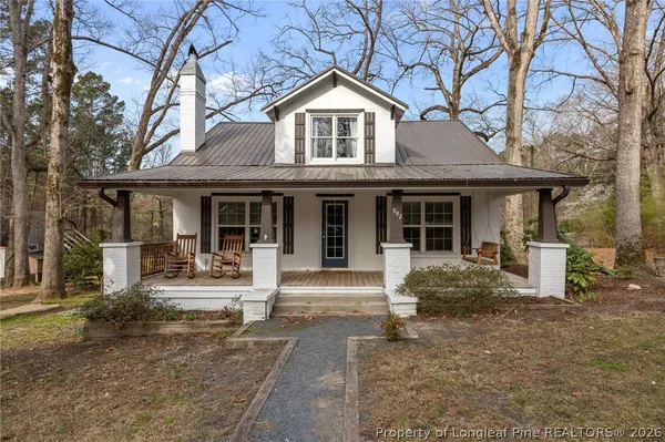 a front view of a house with garden and porch