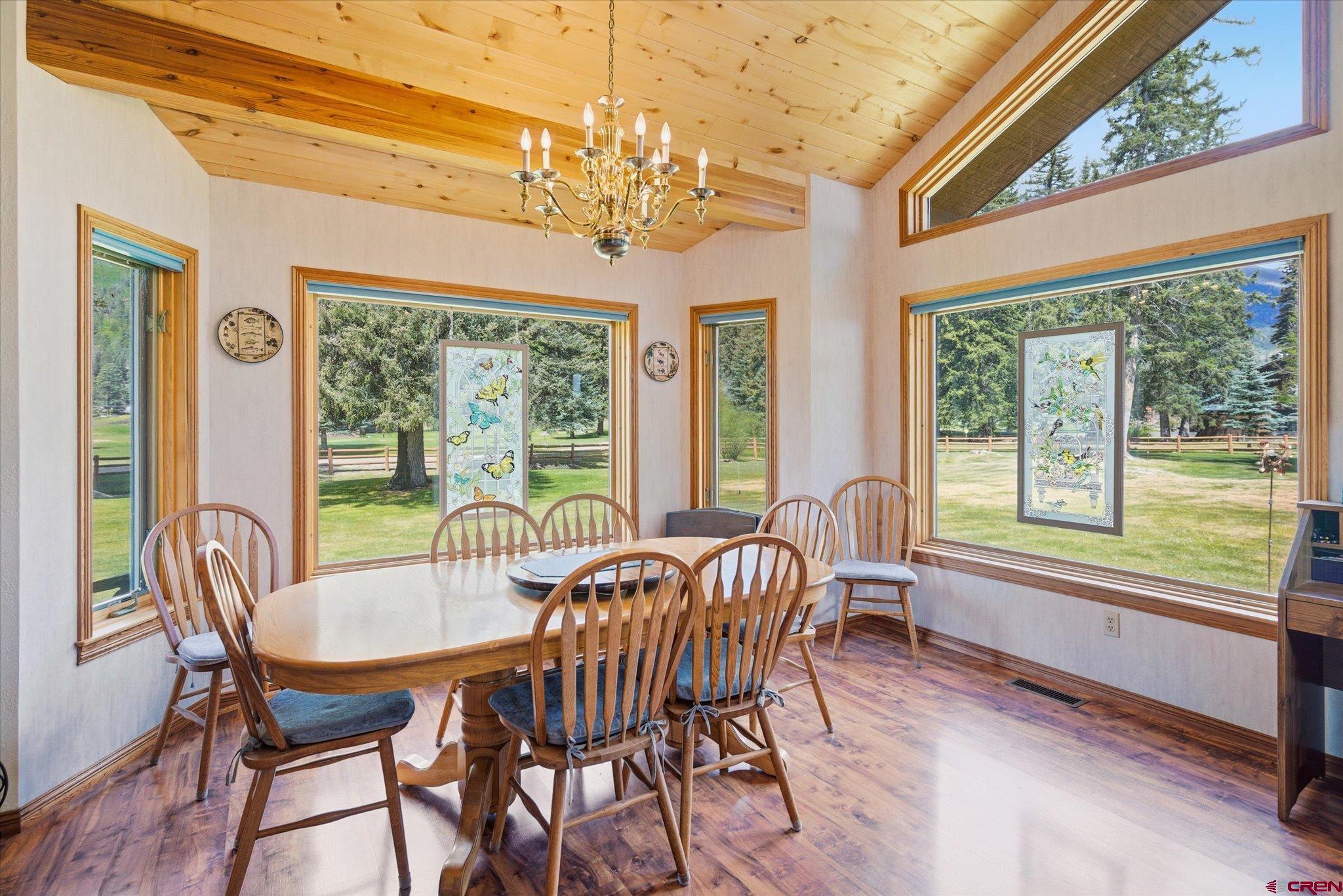 197 Hummingbird Way Bayfield, CO 81122 - Photo 14 of 44 a view of a dining room with furniture a chandelier and wooden floor