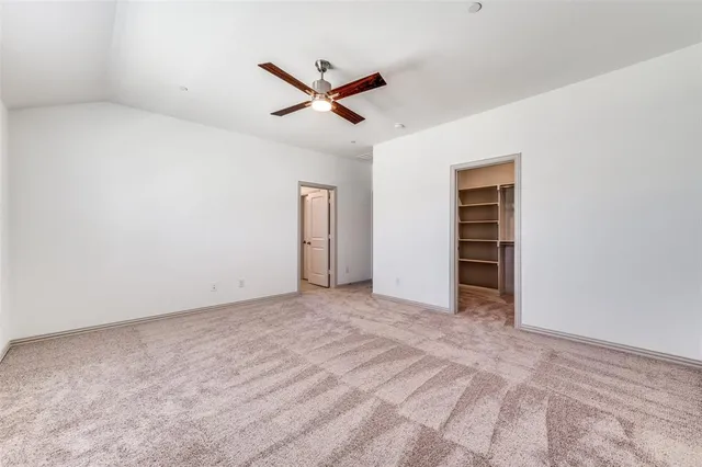 a view of a livingroom with a ceiling fan & entryway