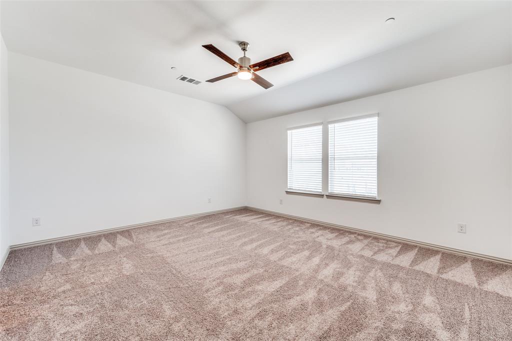 15866 Yellow Elder Road Frisco, TX 75035 - Photo 18 of 29 an empty room with ceiling fan and windows