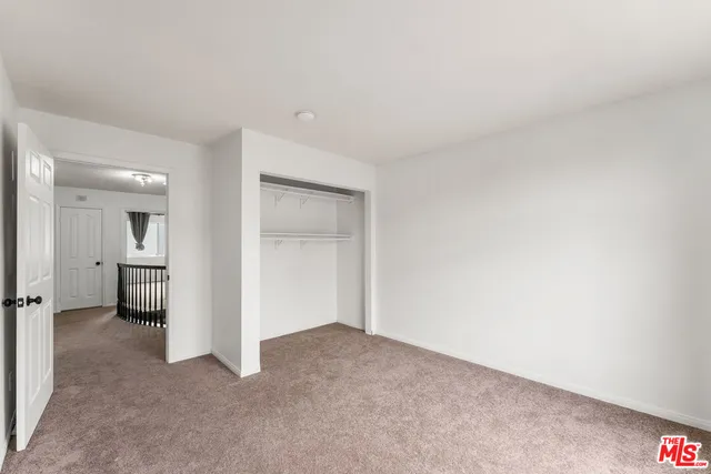 an empty room with a cabinet and a sink