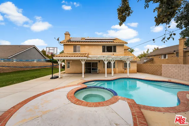 an aerial view of a house with swimming pool and porch