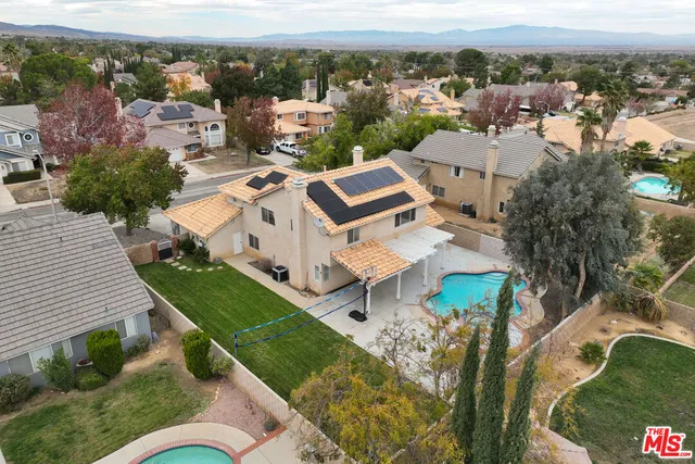 an aerial view of a house with a yard