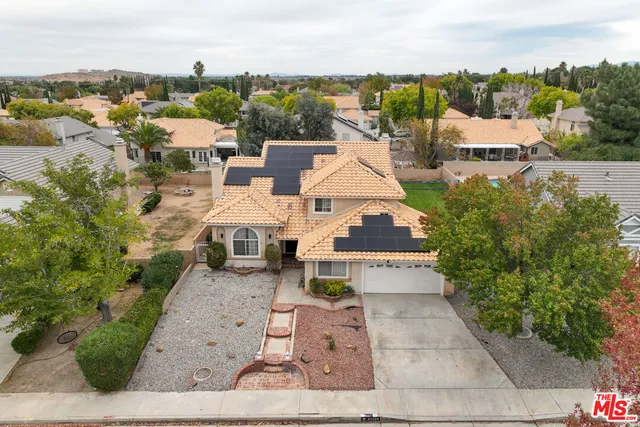 an aerial view of a house with a yard