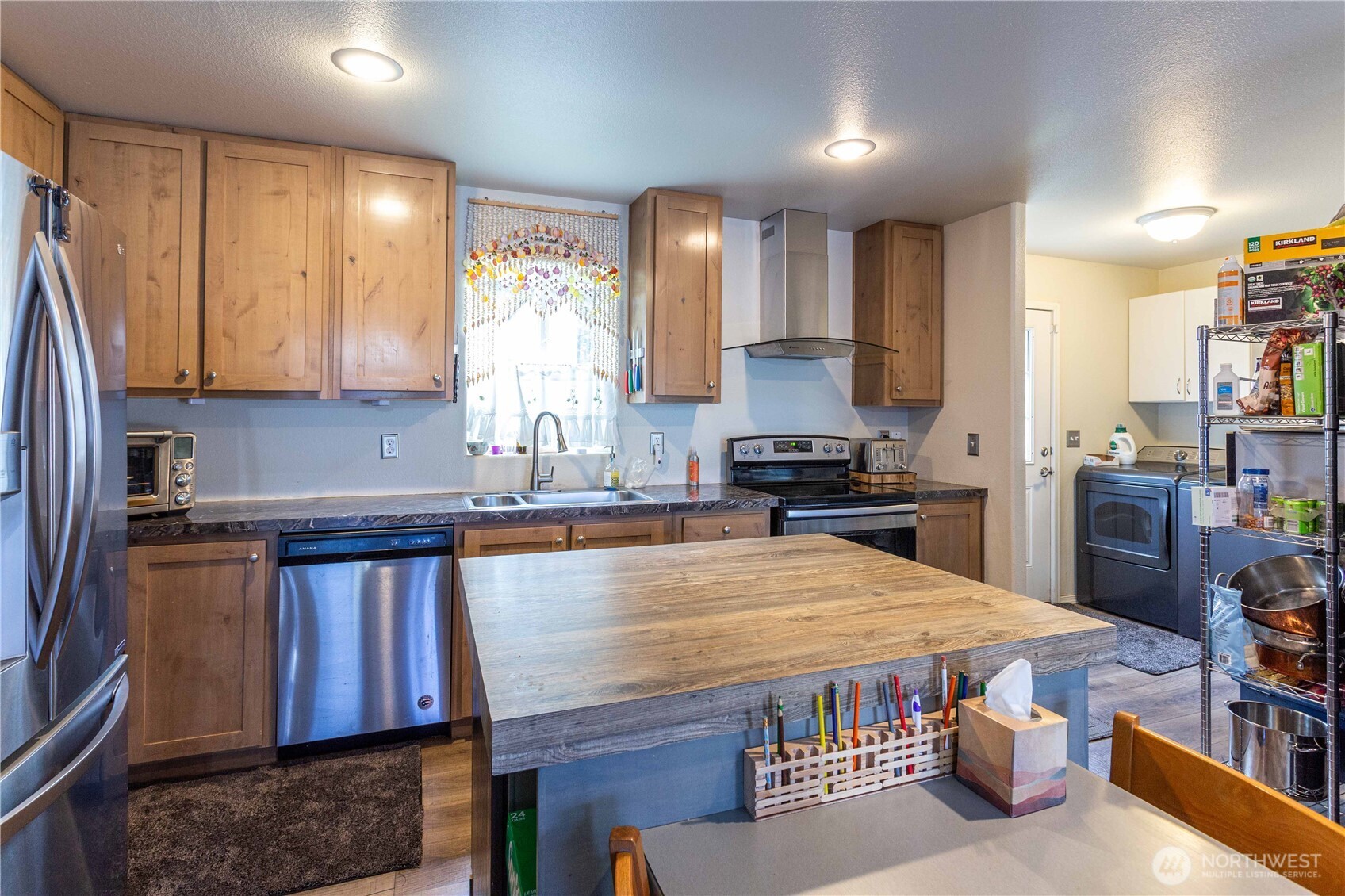 4550 Decatur Drive Ferndale, WA 98248 - Photo 12 of 22 a kitchen with stainless steel appliances a stove a sink and a refrigerator