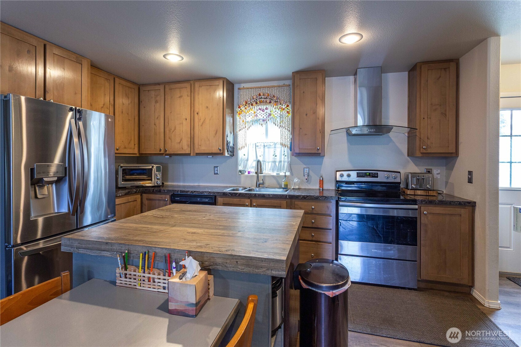 4550 Decatur Drive Ferndale, WA 98248 - Photo 14 of 22 a kitchen with kitchen island a stove and a refrigerator
