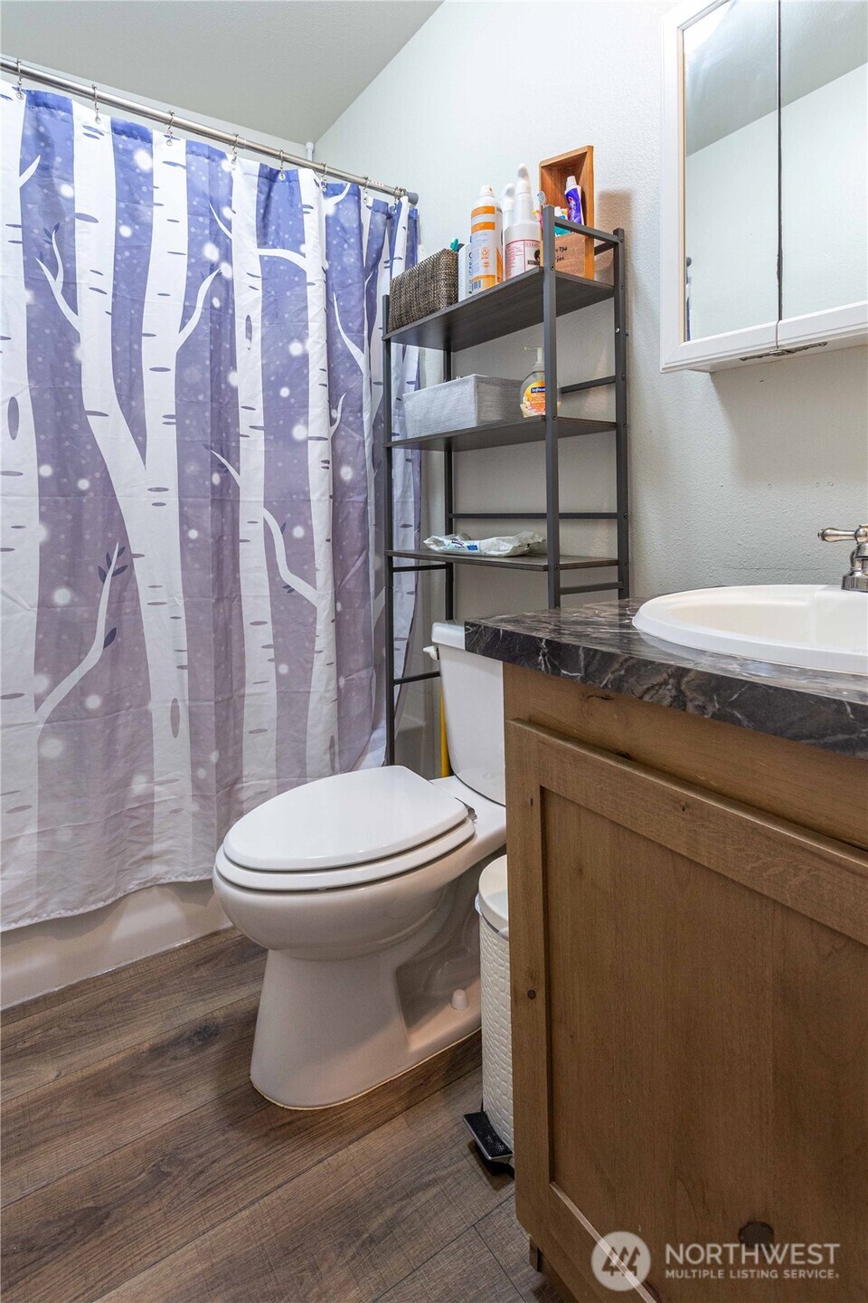 4550 Decatur Drive Ferndale, WA 98248 - Photo 22 of 22 a bathroom with a toilet and a shower curtain