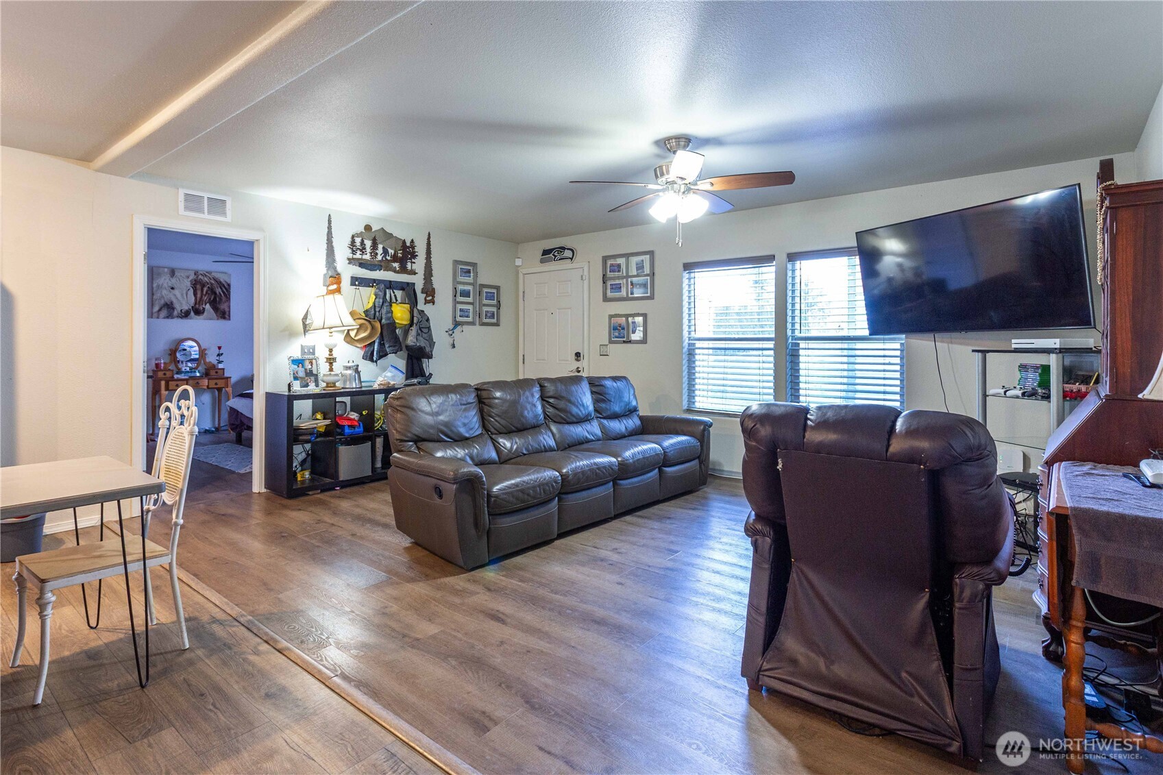 4550 Decatur Drive Ferndale, WA 98248 - Photo 8 of 22 a living room with furniture a flat screen tv and wooden floor