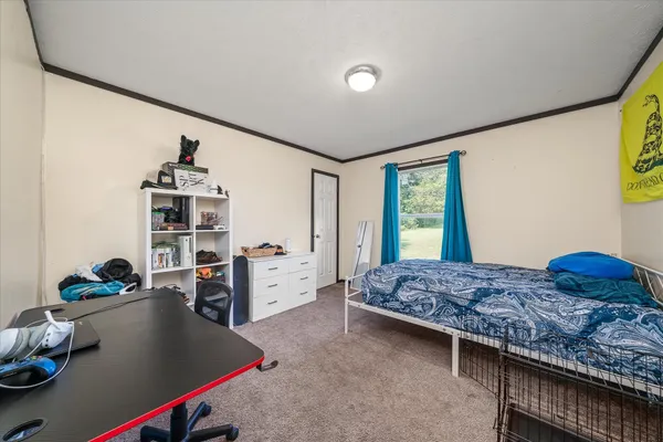 a bedroom with a bed and a window