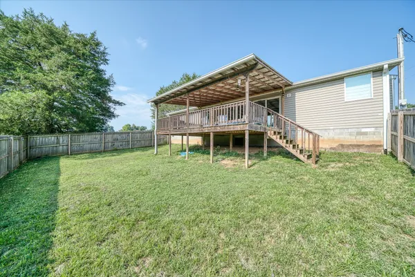 a backyard of a house with table and chairs