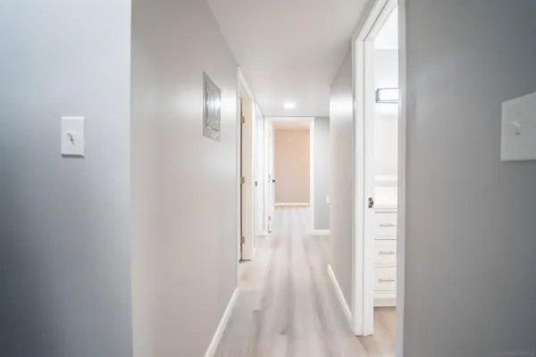 a view of a hallway with wooden floor
