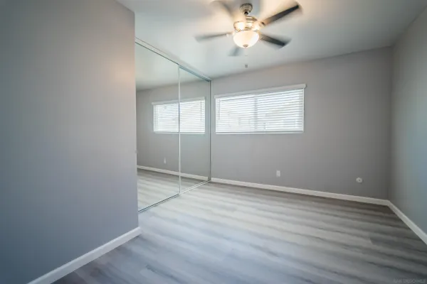a view of an empty room with wooden floor