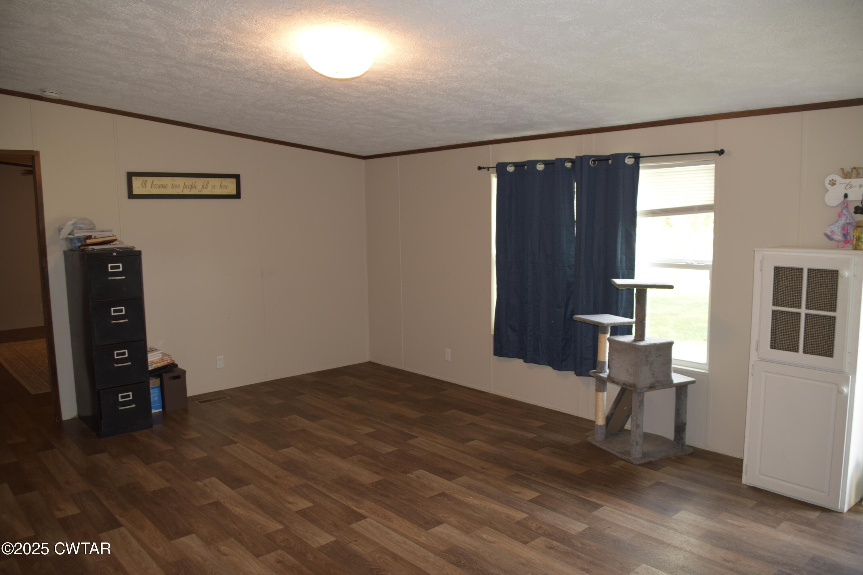 285 Pete Tinsley Road Alamo, TN 38001 - Photo 11 of 27 a view of an empty room with wooden floor and a window