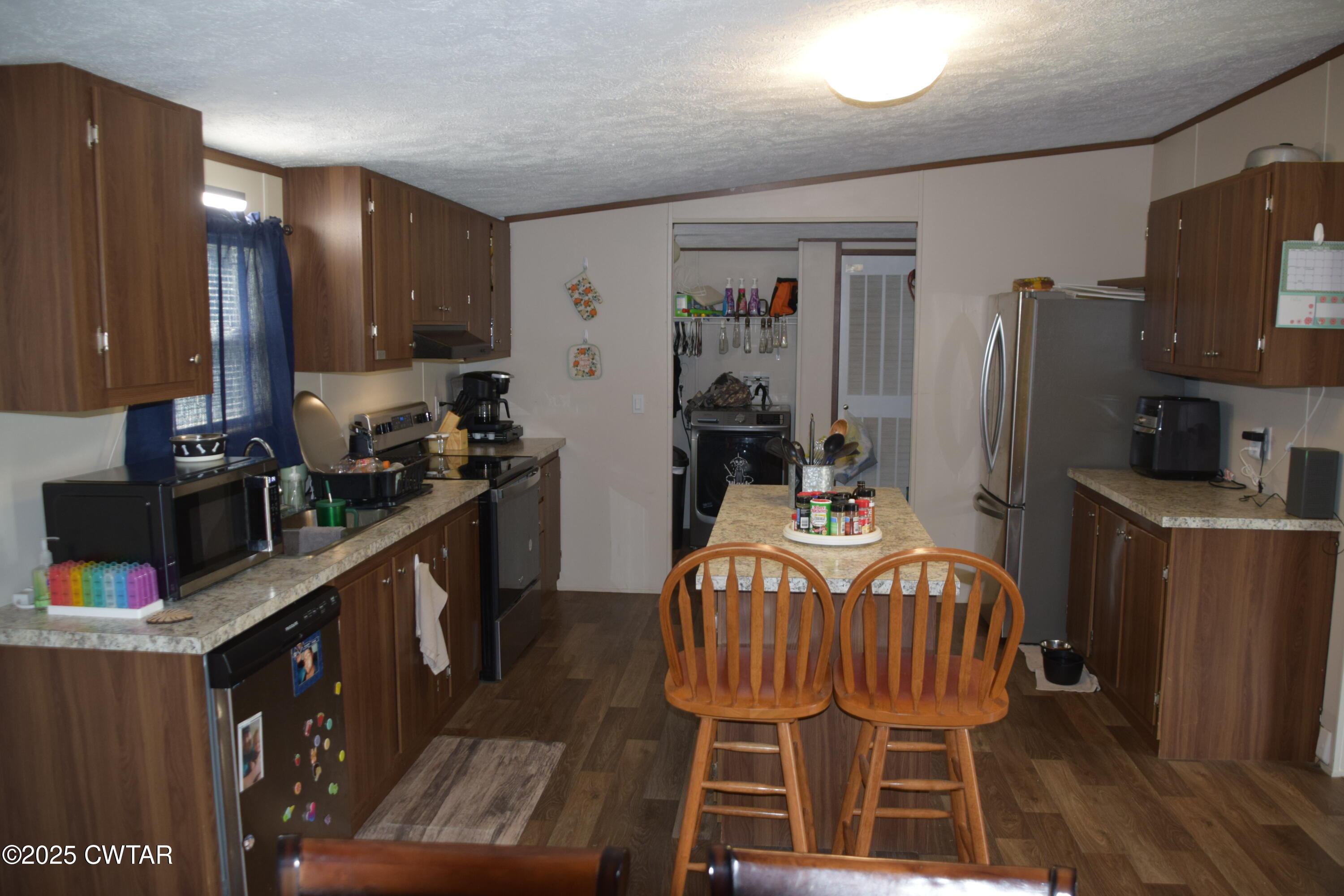 285 Pete Tinsley Road Alamo, TN 38001 - Photo 14 of 27 a kitchen with stainless steel appliances a dining table chairs and a refrigerator