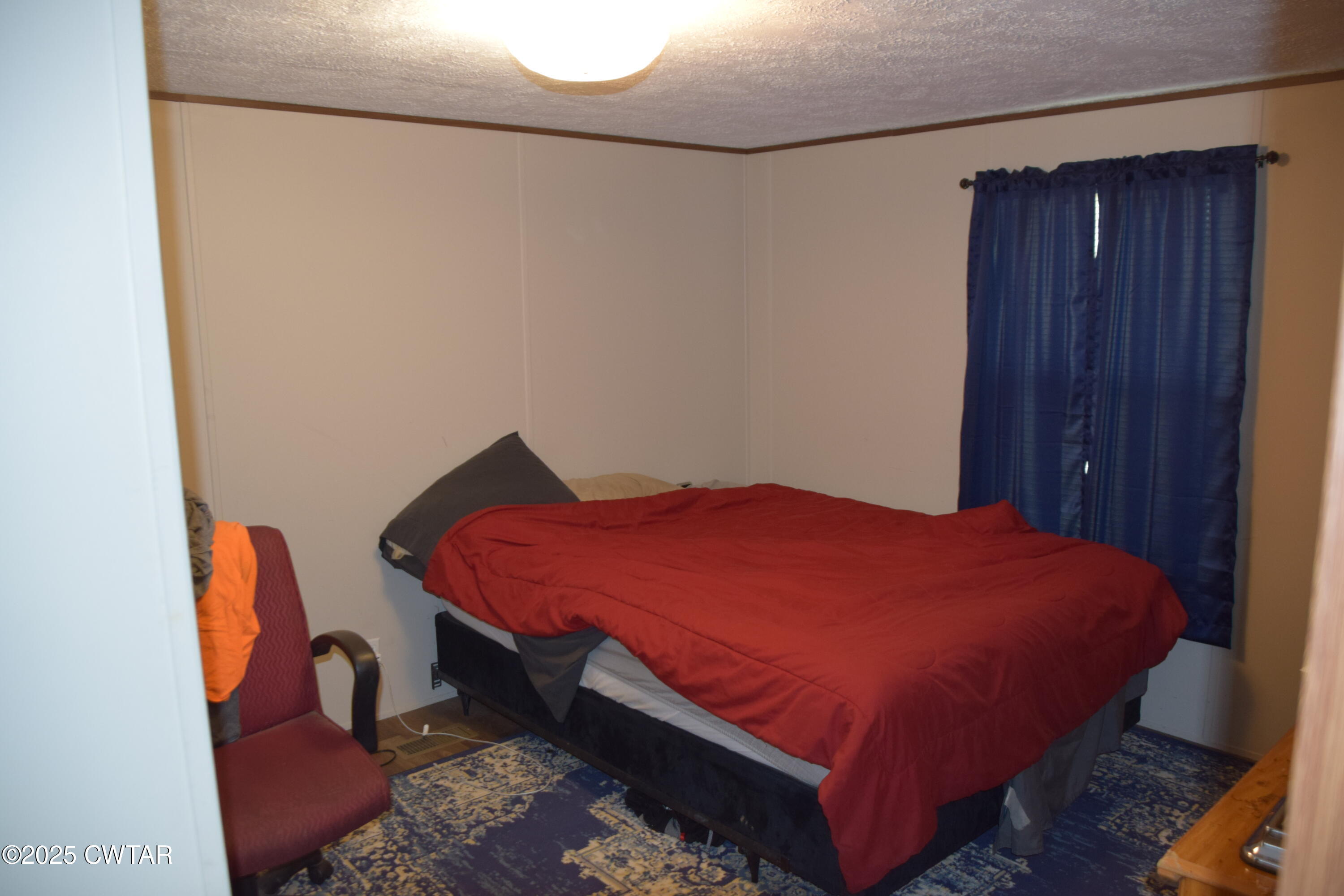 285 Pete Tinsley Road Alamo, TN 38001 - Photo 21 of 27 a bed sitting in a bedroom next to a wooden door