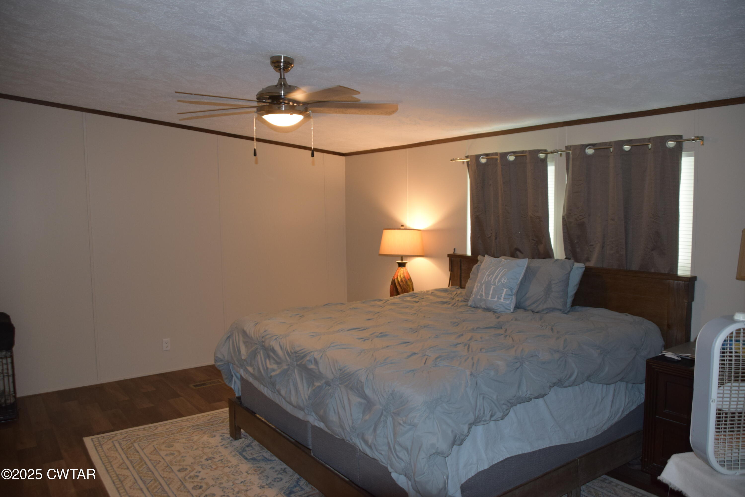 285 Pete Tinsley Road Alamo, TN 38001 - Photo 22 of 27 a bedroom with a bed and a lamp on dresser