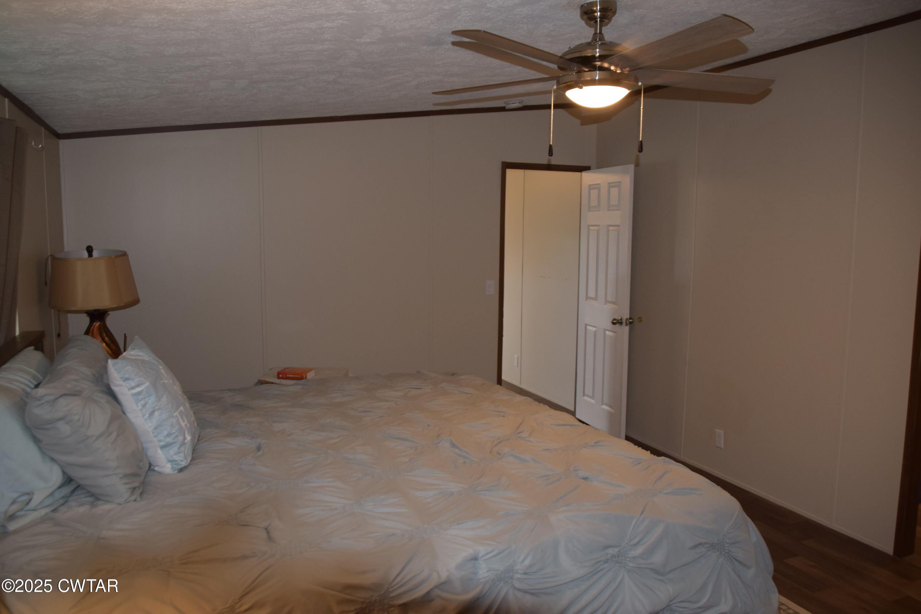 285 Pete Tinsley Road Alamo, TN 38001 - Photo 24 of 27 a bedroom with a bed and a chandelier