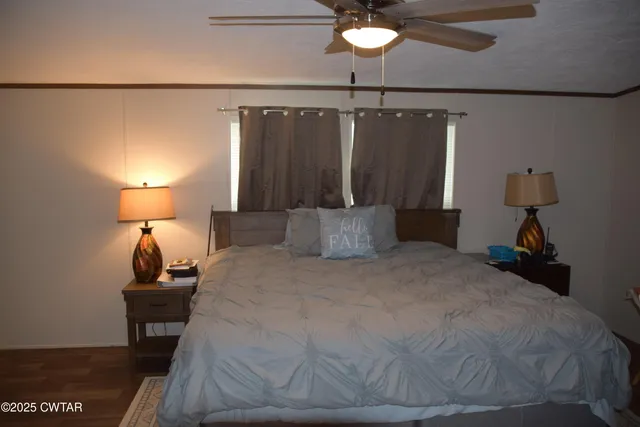a large bed sitting in a bedroom next to a lamp