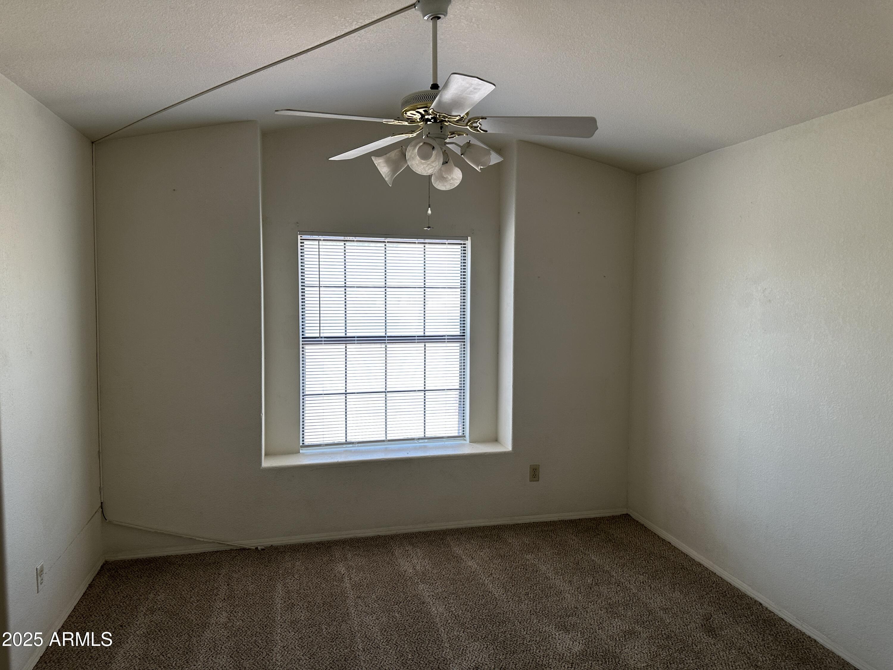 14835 South 26th Way Phoenix, AZ 85048 - Photo 11 of 13 an empty room with windows and fan