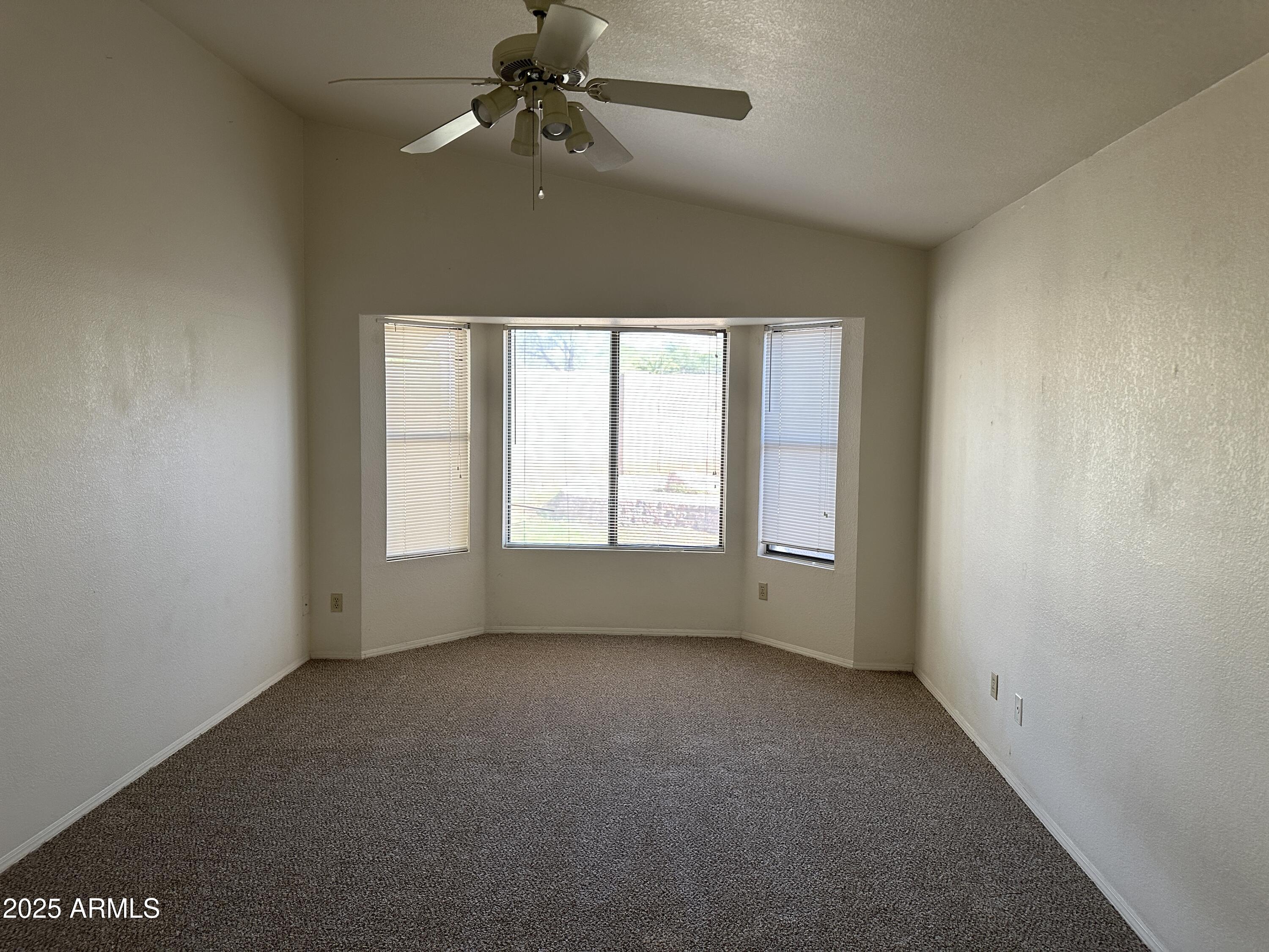 14835 South 26th Way Phoenix, AZ 85048 - Photo 6 of 13 an empty room with a window and a fan