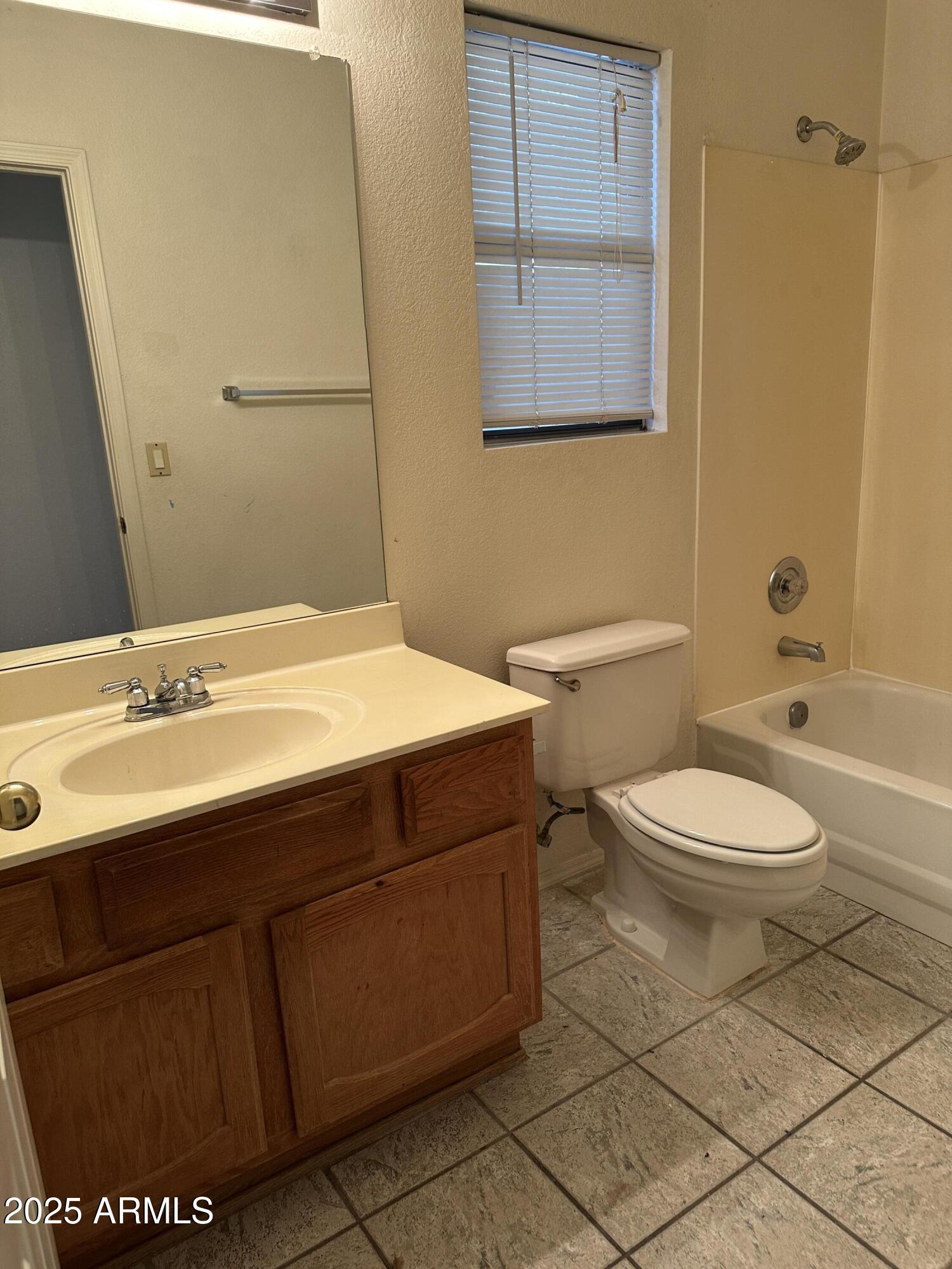 14835 South 26th Way Phoenix, AZ 85048 - Photo 10 of 13 a bathroom with a sink a toilet and shower