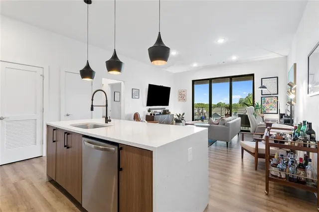 a view of living room with kitchen island furniture and a flat screen tv