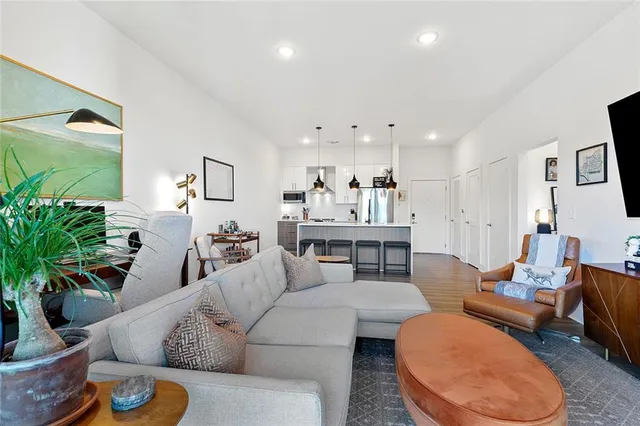a living room with furniture and a potted plant