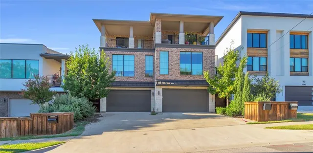 a view of multiple houses with a yard