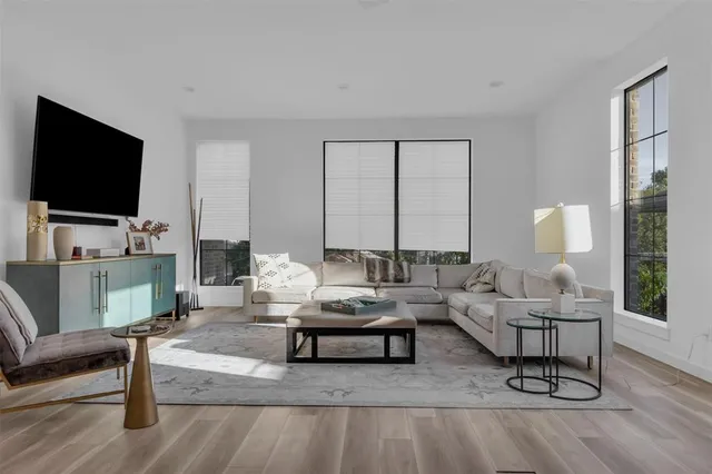 a living room with furniture and wooden floor