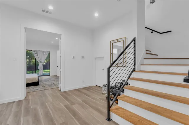 a view of a room with wooden floor and staircase