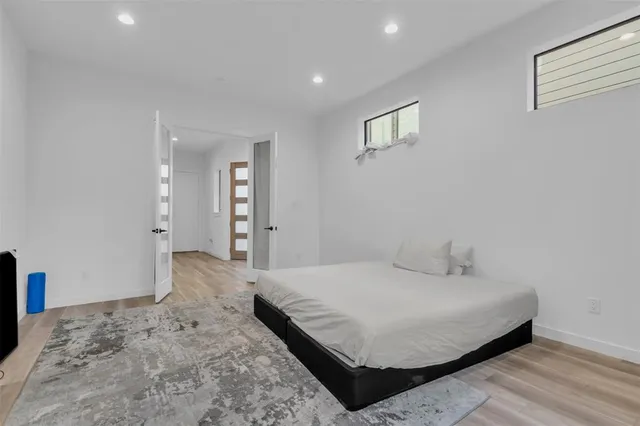 a bedroom with a bed and a window