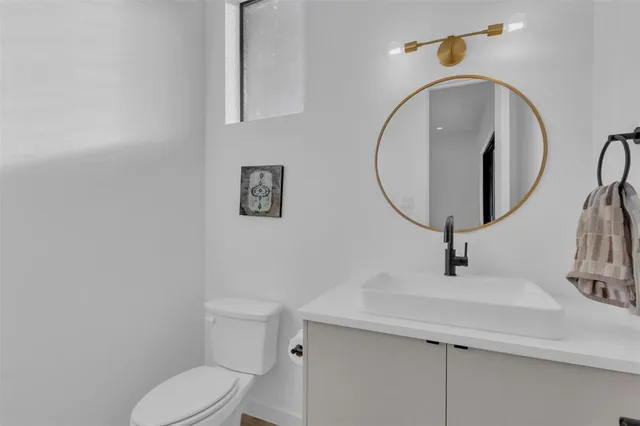 a bathroom with a sink mirror and vanity
