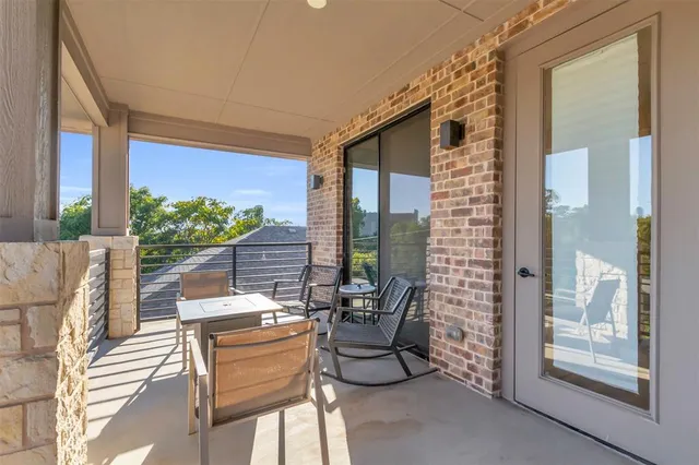 a balcony with furniture and a potted plant