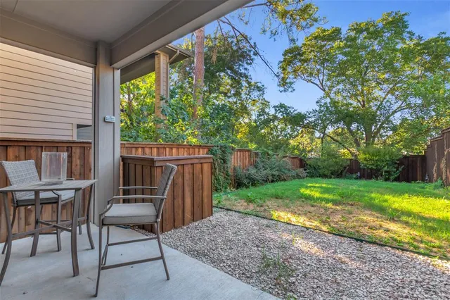 a view of backyard with seating and green space