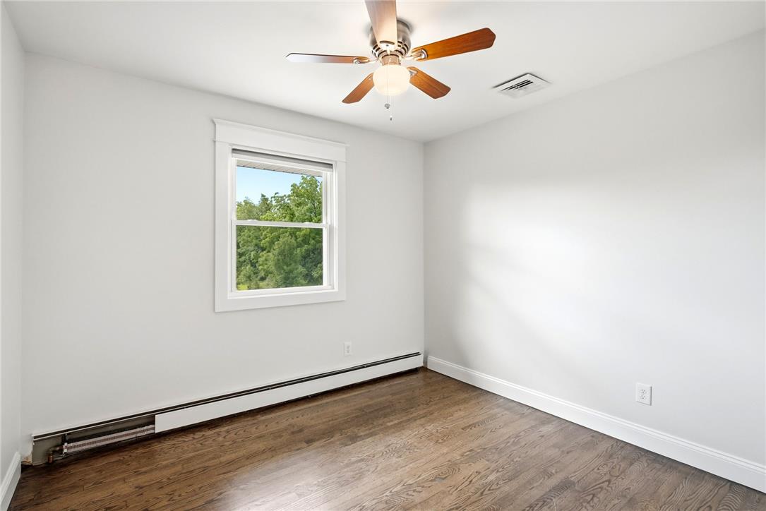 463 North Penn Dixie Road Bath, PA 18014 - Photo 24 of 86 Hardwood flooring complements this airy bedroom, illuminated by a window overlooking verdant foliage.