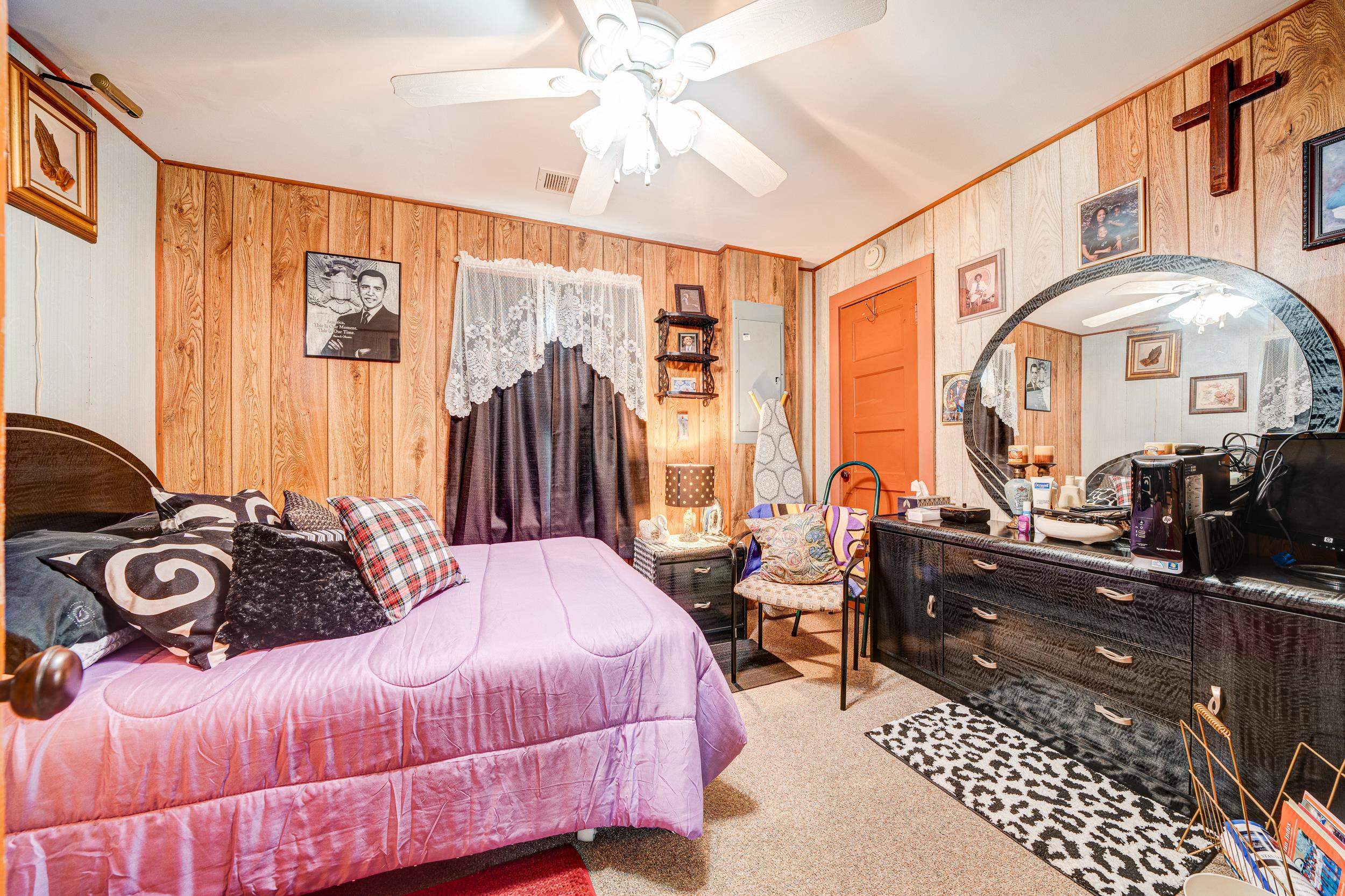 24315 Highway 76 Somerville, TN 38068 - Photo 11 of 27 a bedroom with a bed and a chandelier