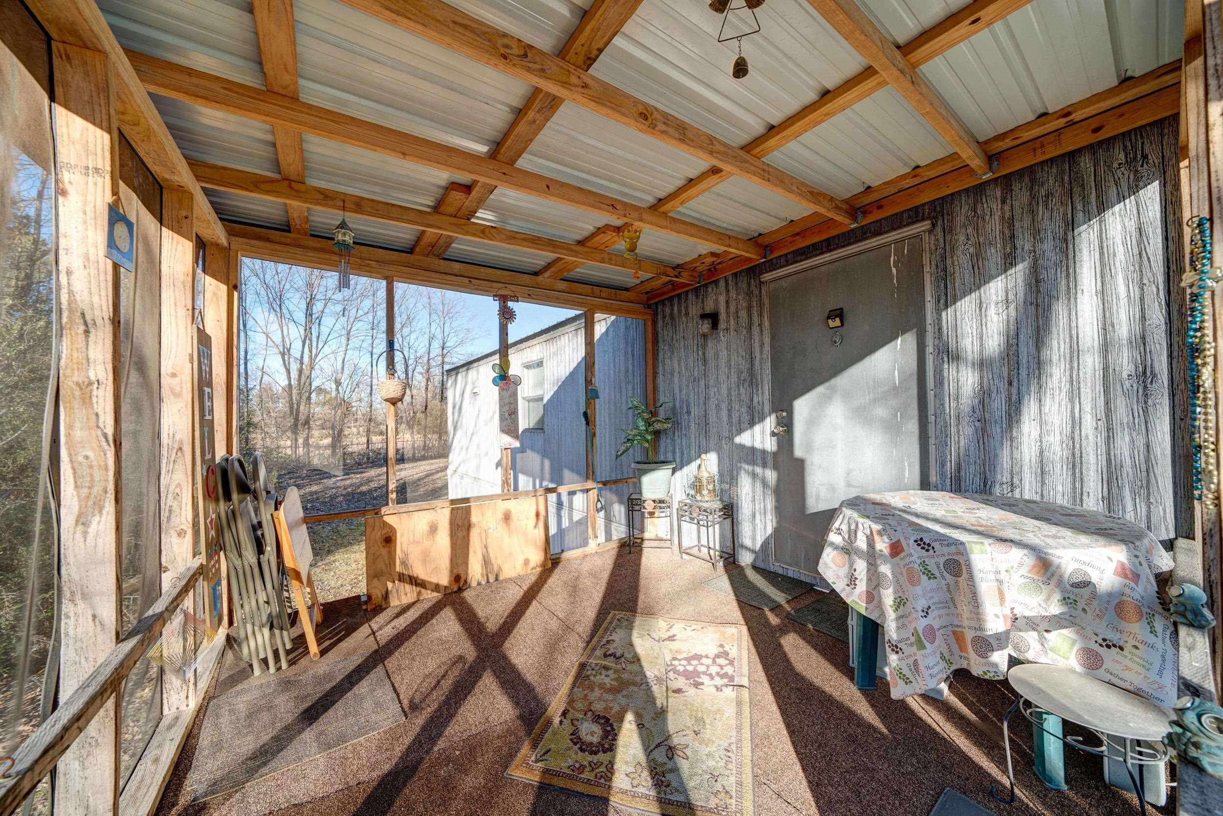 24315 Highway 76 Somerville, TN 38068 - Photo 18 of 27 a view of an outdoor space with wooden floor and windows