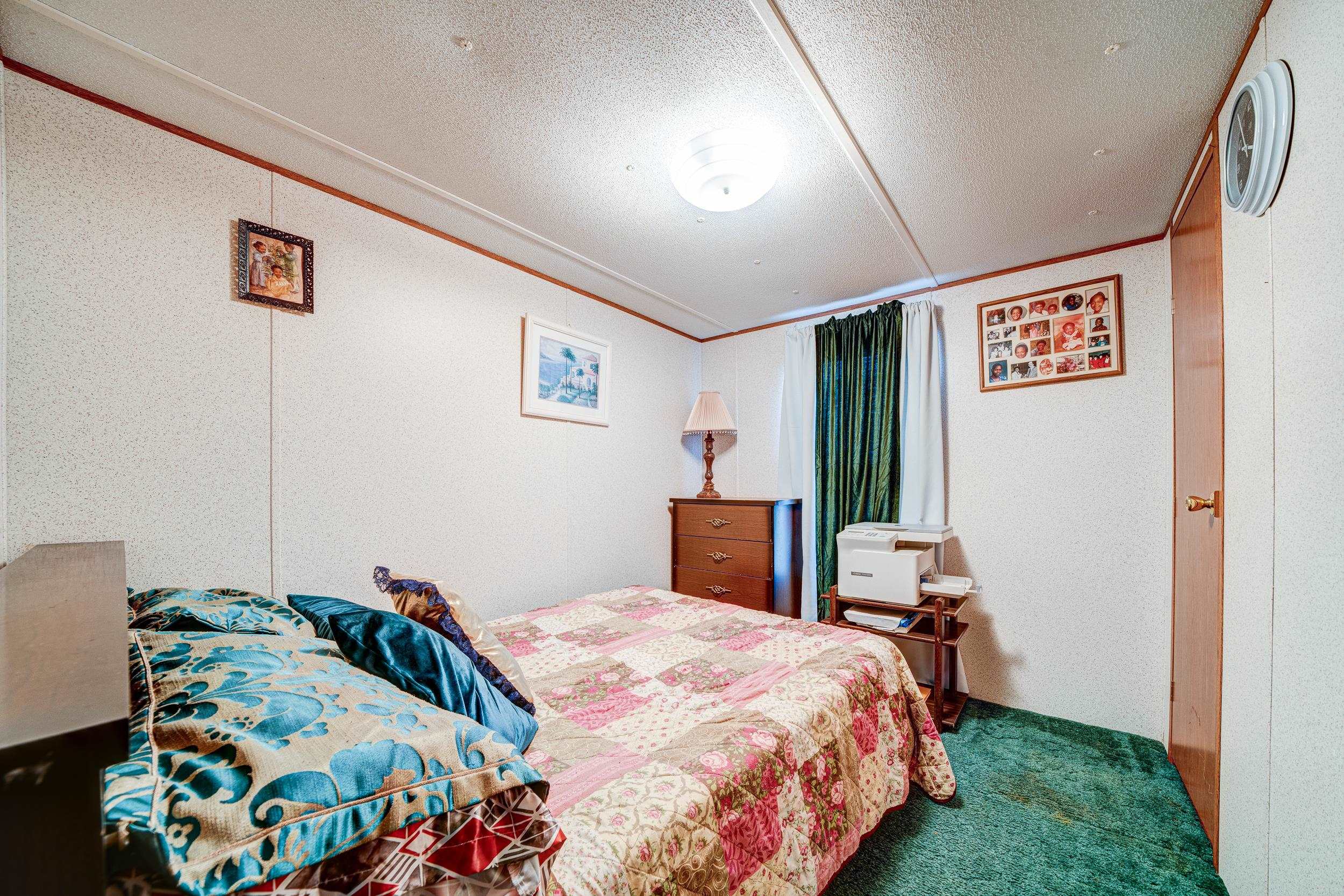 24315 Highway 76 Somerville, TN 38068 - Photo 22 of 27 a bedroom with a bed and a bookshelf