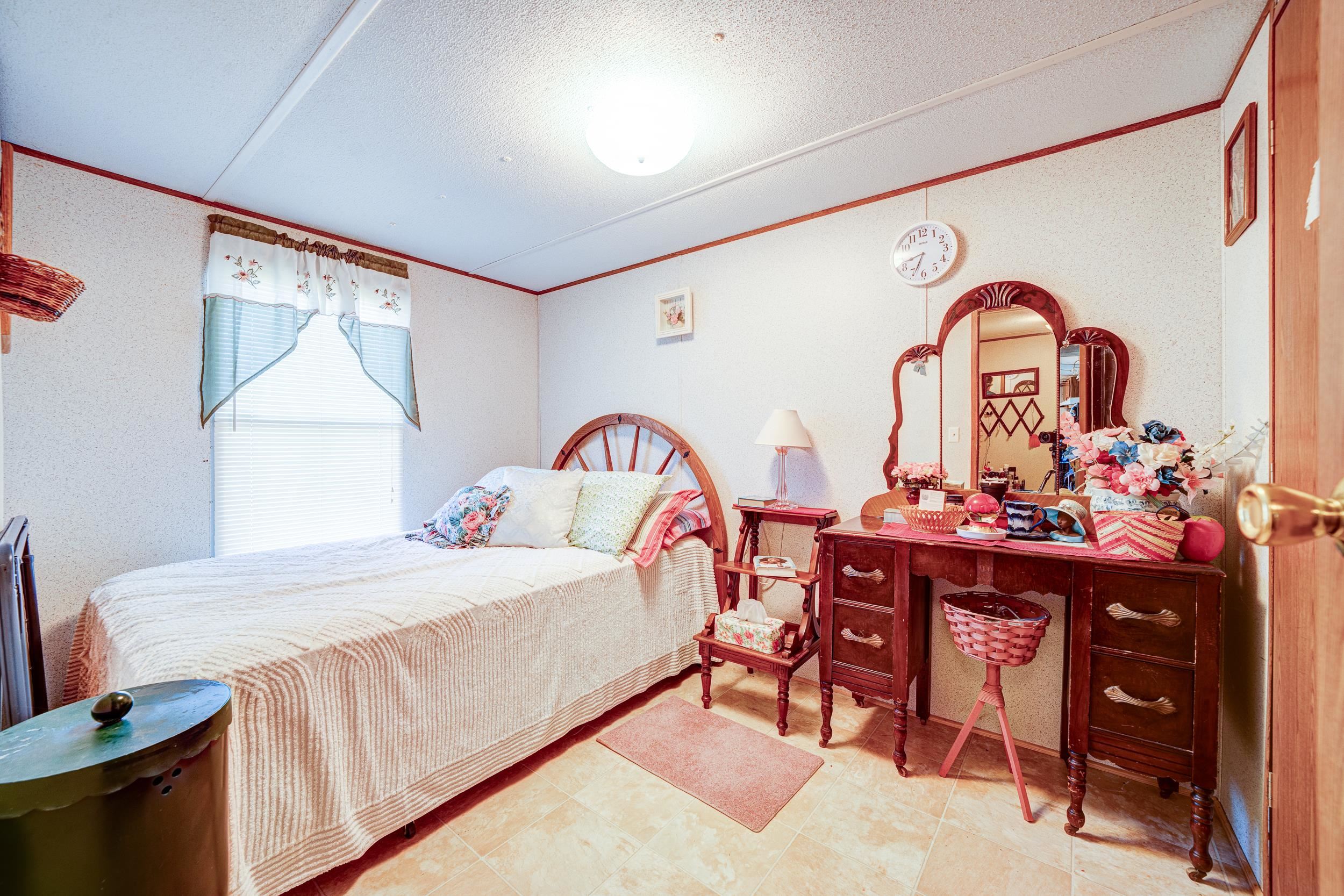 24315 Highway 76 Somerville, TN 38068 - Photo 23 of 27 a bedroom with a bed and a dresser